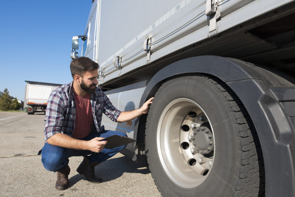 Ban Truk yang Tepat: Kunci Aman Kirim Muatan Berat 1 truck driver inspecting tires checking depth tire tread safe ride