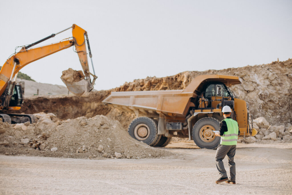 Pentingnya K3 Dalam Sektor Pertambangan 1 Male Worker With Bulldozer Sand Quarry
